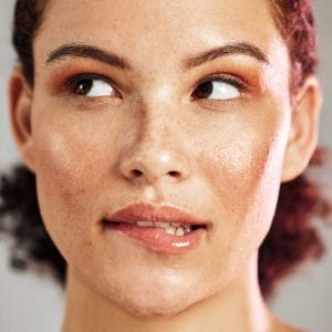 Close-up of woman with freckles and glowing skin