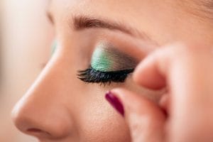 Close-up of eye with green eyeshadow and long lashes