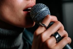 Close-up of person singing into microphone