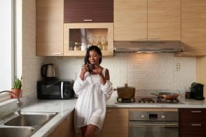 Woman enjoying coffee in modern kitchen