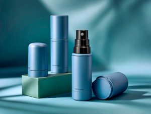 Blue skincare bottles on turquoise backdrop.