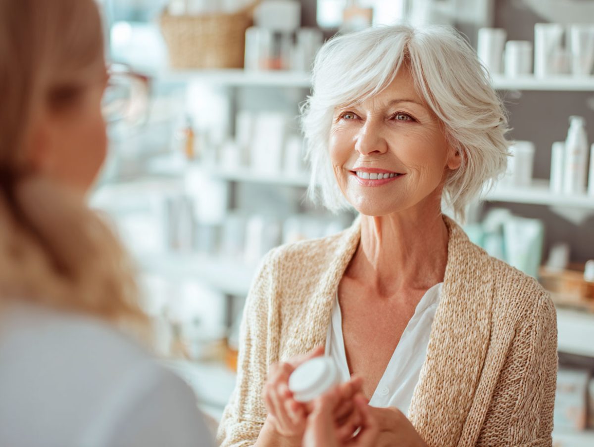 Senior woman smiling at skincare store