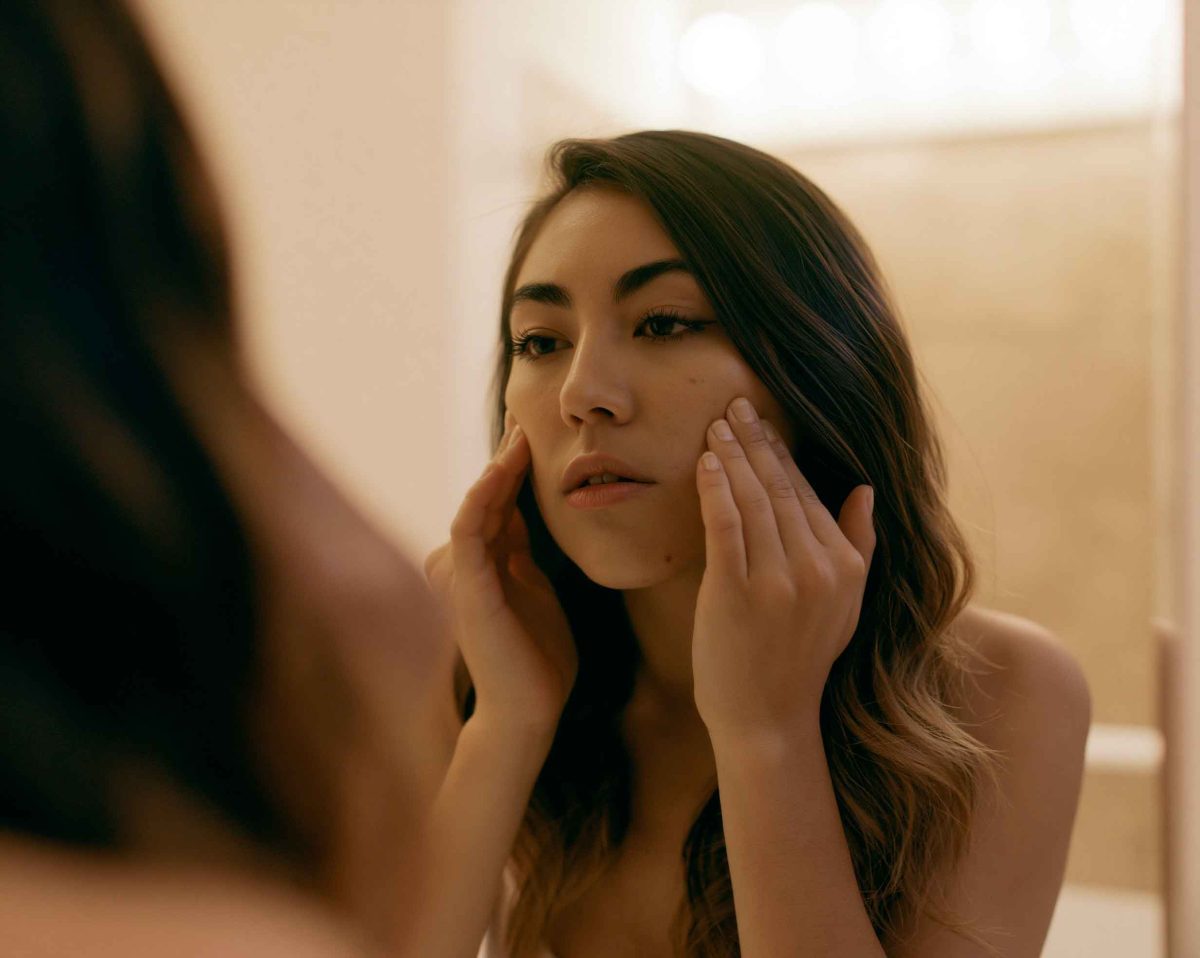 person looking at their reflection in a mirror 98ce1103 1035 49f5 ad40 1be21091c13b 1