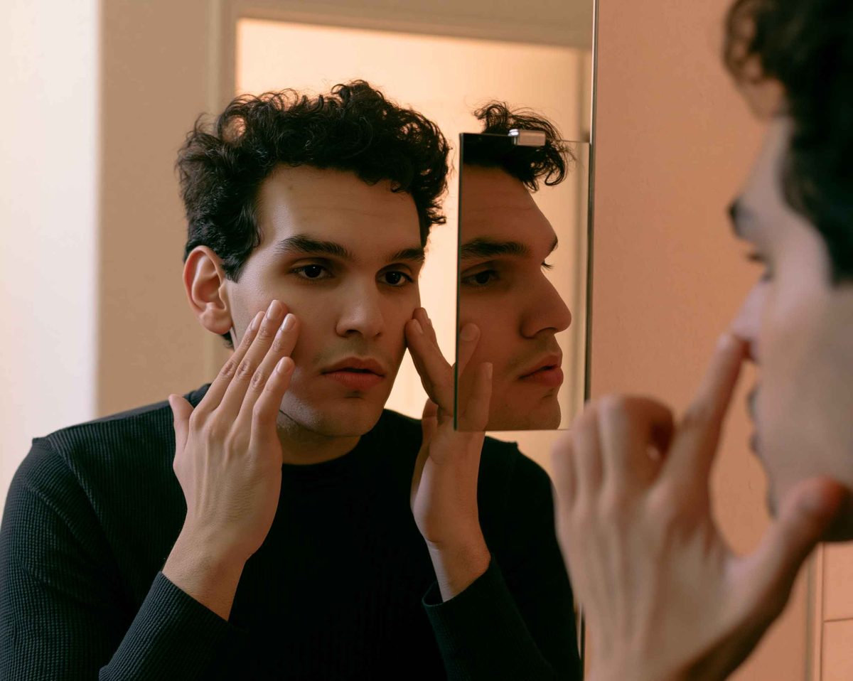 person looking at their reflection in a mirror 98ce1103 1035 49f5 ad40 1be21091c13b 3