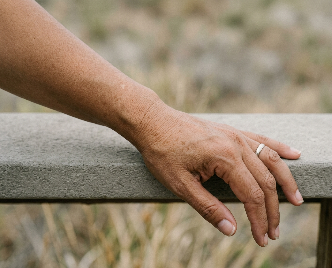 Close-up of forearm with sun spots on olive-to-brown skin in natural light
