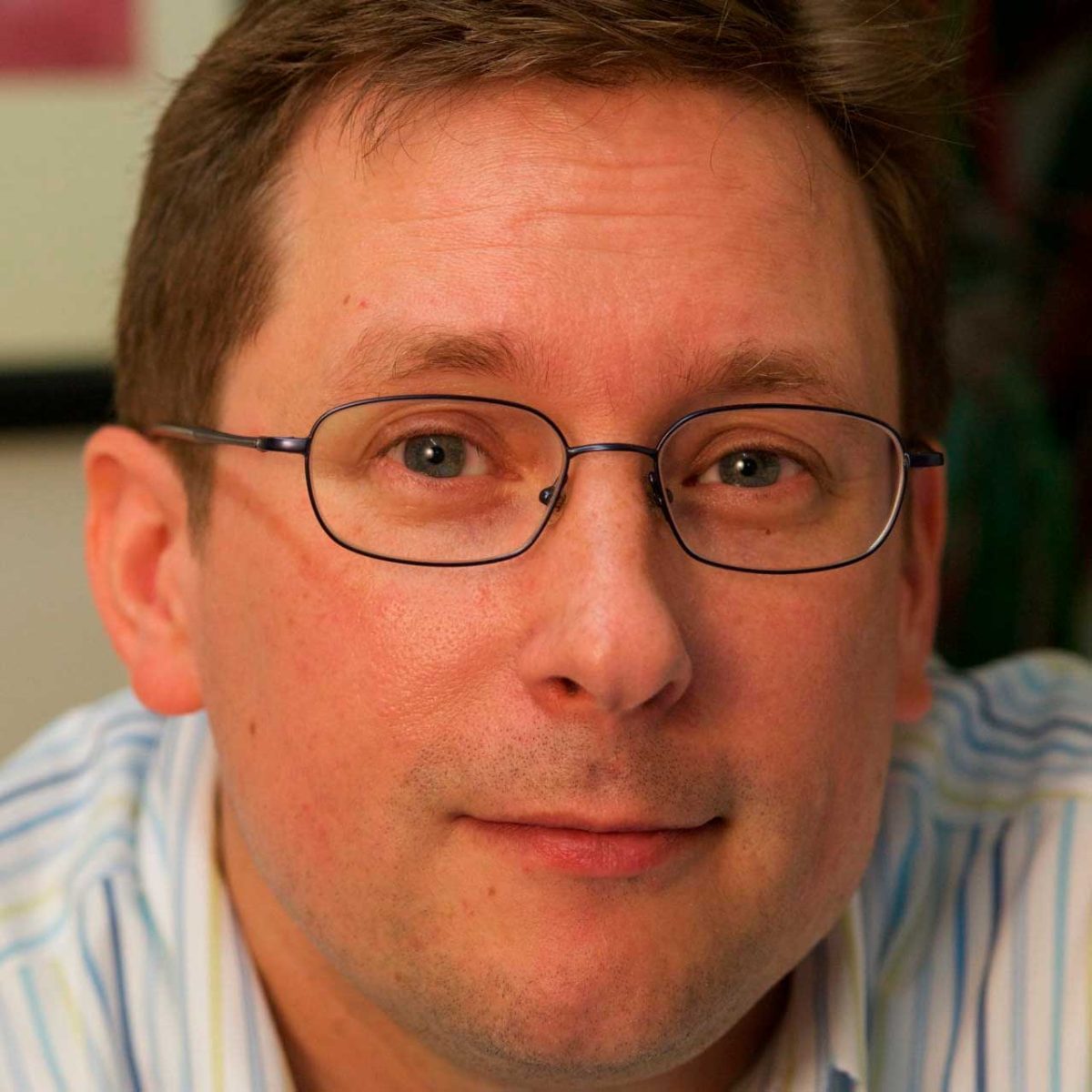 Close-up portrait of man wearing rectangular glasses