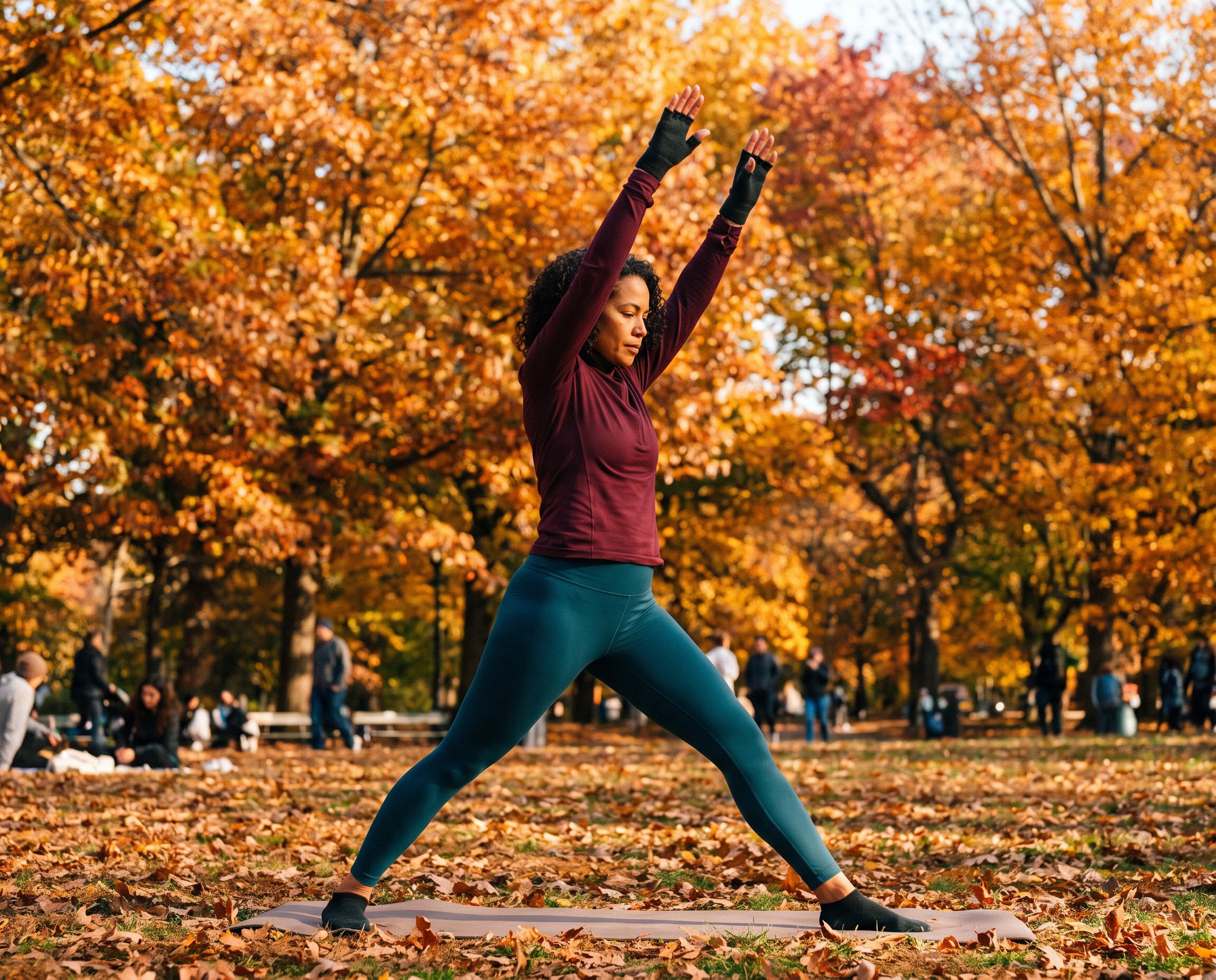 Woman stretching outdoors during yoga in a park in autumn with a neat manicure visible